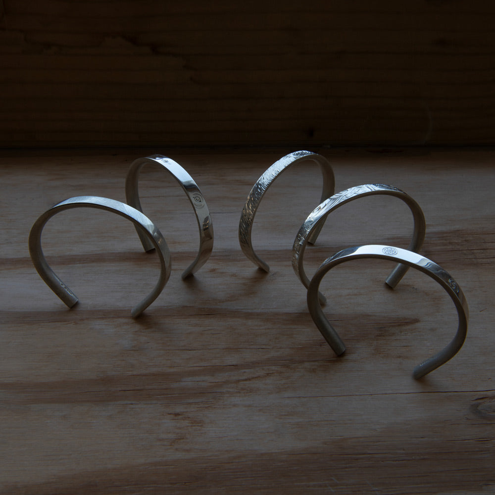 Silver bracelets for men. Each one celebrating the art of hand engraving. Sterling silver and made in the UK. 